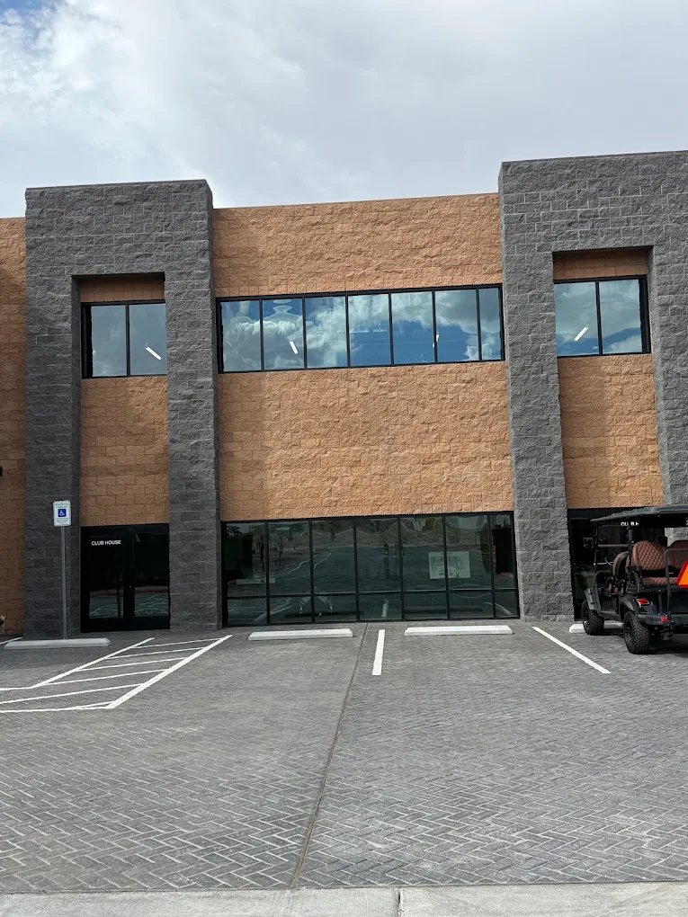 Exterior of the clubhouse building at The Stack Auto Lofts, with stone columns and tall windows